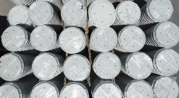 Top-down view of wrapped circular composite manhole covers ready for shipment.