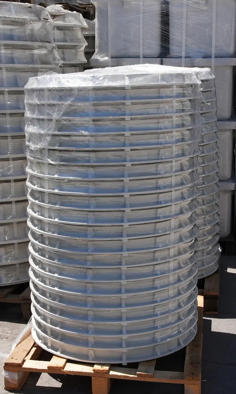 Palletised composite covers wrapped for transport protection.