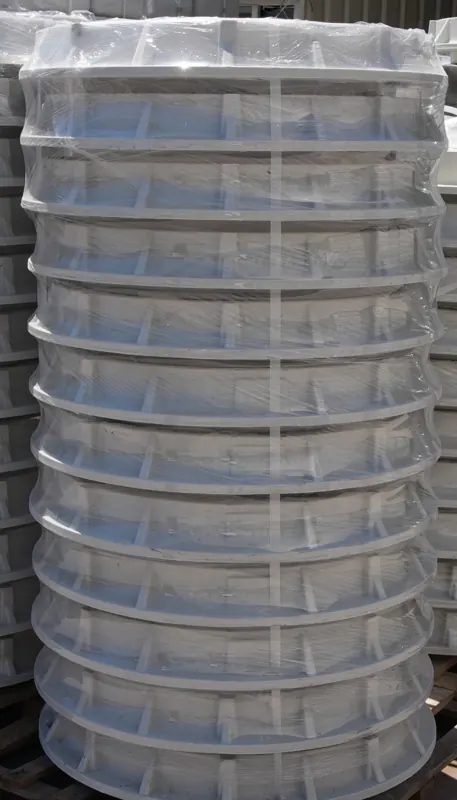 Stacked circular composite riser bodies wrapped for storage and transport.